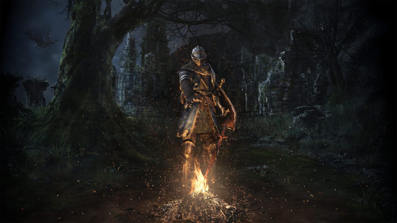 A screenshot from Dark Souls Remaster of a knight standing by a fire in the dark